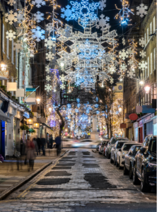 Christmas lights and snowflakes above a street